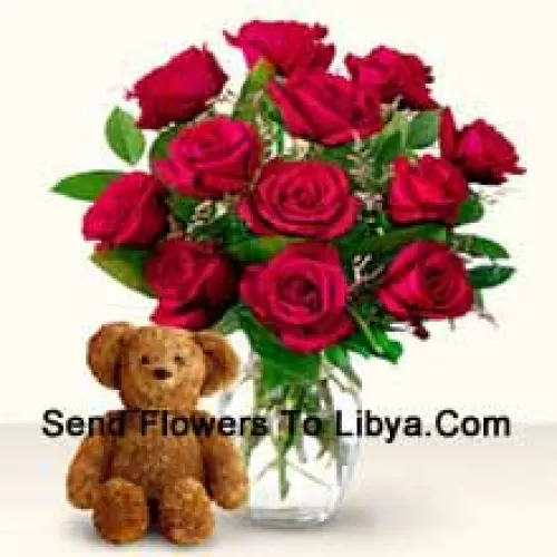 12 Red Roses With Some Ferns In A Glass Vase Along With A Cute 12 Inches Tall Brown Teddy Bear