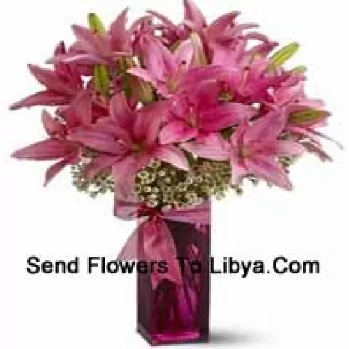 Beautiful Pink Lilies With Some Ferns In A Glass Vase