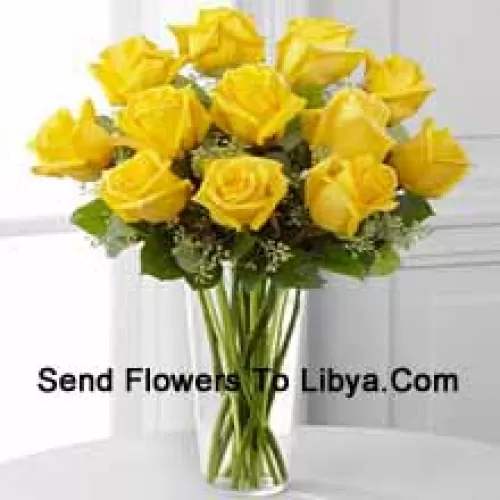 12 Yellow Roses With Some Ferns In A Glass Vase