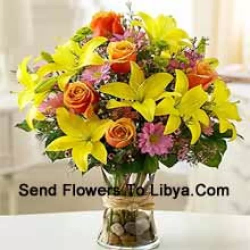 Yellow Lilies, Orange Roses And Pink Gerberas With Seasonal Fillers In A Glass Vase