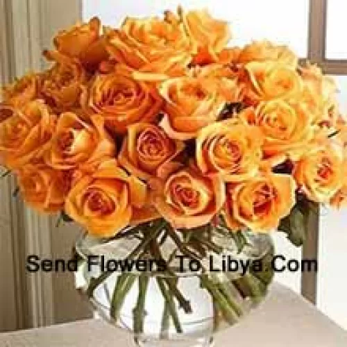 24 Orange Roses With Some Ferns In A Glass Vase