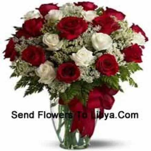 12 Red And 12 White Roses With Some Ferns In A Glass Vase