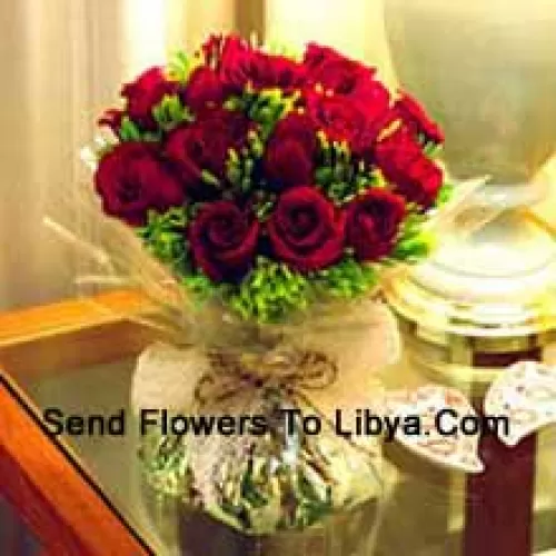 12 Red Roses With Some Ferns In A Vase