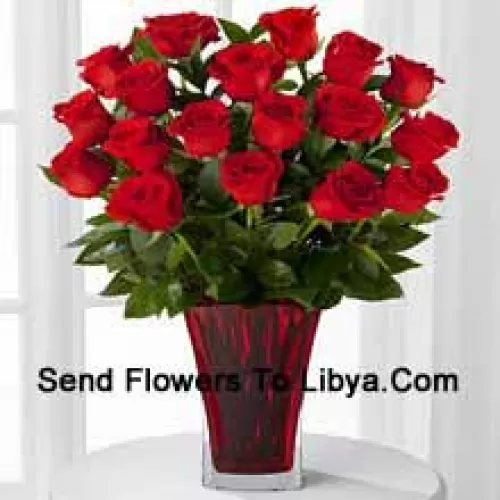 18 Red Roses With Seasonal Fillers In A Glass Vase Decorated With A Pink Bow