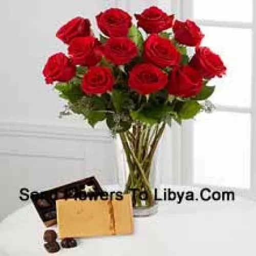 12 Red Roses With Some Ferns In A Vase And A Box Of Godiva Chocolates (We reserve the right to substitute the Godiva chocolates with chocolates of equal value in case of non-availability of the same. Limited Stock)